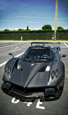 a black sports car parked in a parking lot