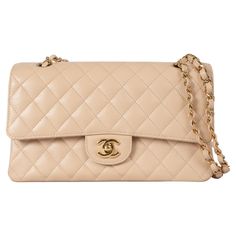 This 100% authentic Chanel Classic Medium 11.12 double flap shoulder bag is crafted from beige quilted Caviar leather with gold-tone hardware. It features an open outside pocket on the back and a classic double chain strap interlaced with leather. The bag opens with the iconic CC turnlock, followed by a second flap with a snap-button closure. The outter flap includes a discreet zipper pocket, traditionally known for storing love letters. The interior is lined in beige leather and includes a lipstick pocket and two open pockets against the back, offering both elegance and practicality. Has been carried and is in excellent condition. Measurements Model ChanelREV A01112 Y01864 21209 Height 16cm (6.2in) Width 25.5cm (9.9in) Depth 6.5cm (2.5in) Drop of the Handle 24cm (9.4in) Shoulder Strap Len Chanel Classic Medium, Chanel Beige, Double Chain, Chanel Handbags, Flap Bag, Luxury Handbags, Fashion Handbags, Chain Strap, Chanel Classic