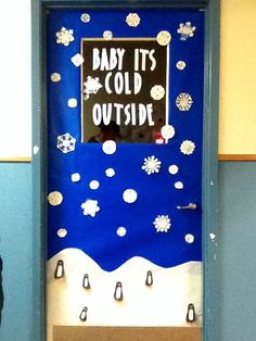 a door decorated with snowflakes and a sign that says baby it's cold outside