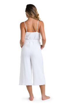 Packed itinerary? Be sure to schedule a date with this white jumpsuit cover up. The perfect travel companion, this sexy number has a V-neck front and lingerie straps for figure-flattering style. Looks just as fabulous with heels as it does with sandals. [split] Details Jumpsuit cover up Adjustable straps Crochet side panel detail Wide legs, cropped length Belted Side pockets Fully lined Fabric 100% Cotton Vacation Jumpsuits And Rompers With Adjustable Straps, Jumpsuits And Rompers With Adjustable Straps For Vacation, White Strapless Jumpsuit For Spring Beach Outing, Chic Jumpsuits And Rompers With Adjustable Straps For Vacation, White Strapless Sleeveless Jumpsuit For Summer, White Jumpsuits And Rompers For Beach Day Out, Chic Spaghetti Straps Jumpsuits For Beach Season, White Jumpsuits And Rompers For Summer Loungewear, Chic Spaghetti Strap Jumpsuits And Rompers For Vacation