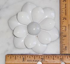 This listing is for a Vintage White Metal Daisy Flower Brooch ~ Classic 1960s ~ Unsigned. The color is a greyish white~ it has a grey tone to it. This is a metal piece, not plastic. This is not marked, stamped or dated as far as I can tell. It is very old and Measures 2 7/8 inches round. See pics. Vintage White Flower Brooches, White Vintage Flower Brooches, Vintage White Flower Brooch, Blue Glass Vase, La Crosse, Vintage Cabinets, Brooch Vintage, Easter Table, Grey Tones