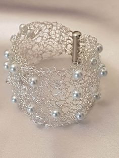 a silver bracelet with pearls on it