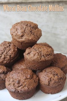 chocolate muffins stacked on top of each other on a white plate with the words wheat bran chocolate muffins