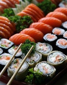 sushi platter with carrots, broccoli and other foods on it