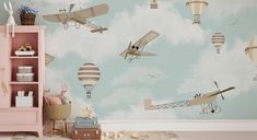 a child's room with an airplane and hot air balloons painted on the wall