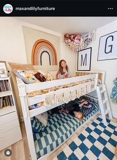 two children are sitting on the bottom bunk of a bed in a room with bookshelves