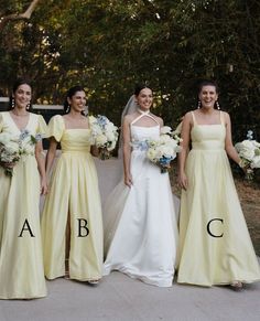 four bridesmaids in yellow dresses with their names on the front and back, all holding bouquets