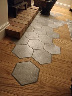 a wooden floor with several hexagonal tiles on it