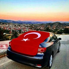 a car parked on the side of a road with a turkish flag painted on it