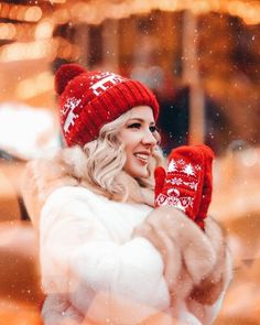 a woman wearing a red knitted hat and mittens