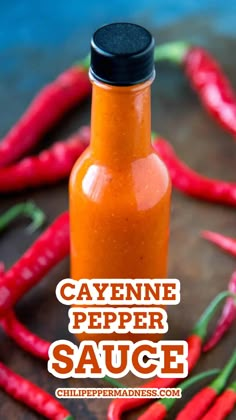 a bottle of cayenne pepper sauce surrounded by chili peppers