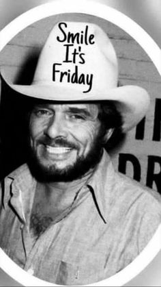 a man wearing a hat with the words smile its friday written on it in black and white