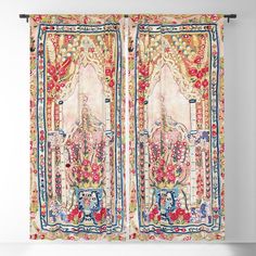 an ornately decorated curtain hangs in front of a white wall with two doors and floral decorations