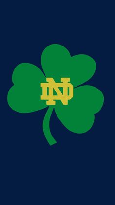 a four leaf clover with the letter n in it's center on a dark blue background