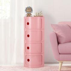 a pink dresser in the corner of a room with a teddy bear on it's top