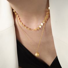 ✦Simplicity meets elegance with our Simple Gold Disc Ball Pendant Necklace. The minimalist design of this necklace showcases a sleek and polished ball pendant suspended from a two-strand chain. The gold color adds a touch of warmth and sophistication to your neckline. Whether you're layering it with other necklaces or wearing it on its own, this versatile piece is a must-have in your jewelry collection. Effortlessly stylish and timeless, it's perfect for any occasion and complements a wide range Elegant Layered Necklace With Double Chain And Round Pendant, Elegant Layered Necklace With Delicate Chain And Round Pendant, Elegant Layered Necklace With Round Pendant, Elegant Gold Plated Necklaces With Ball Chain, Elegant Gold Layered Round Necklace, Elegant Gold Layered Necklace With Round Pendant, Elegant Gold Drop Necklace For Layering, Elegant Gold Layered Necklace, Gold Layered Necklace With Round Pendant And Double Chain