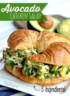 a croissant sandwich with avocado and spinach on it