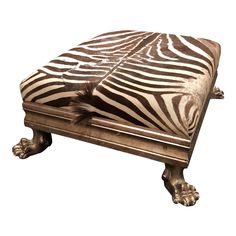 a zebra print ottoman sitting on top of a wooden table