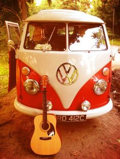 an old vw bus with a guitar attached to it