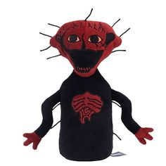 a red and black stuffed animal with big eyes on it's head, arms and legs