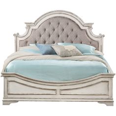 a white bed with blue sheets and pillows on it's headboard, in front of a white background