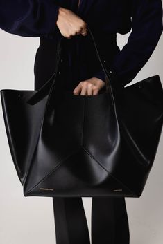 Victoria Beckham w11 medium tote bag in black. 100% Leather Short Strap: 32.5cm, Long Strap: 79cm Base: 29cm X 27cm, Height: 30cm, Top Width: 44cm Fits Iphone 15 Pro Max Snap Buttons, Internal Pocket Compartment Made in Italy Large Modern Satchel With Handles, Large Modern Satchel, Large Modern Satchel With Dust Bag, Modern Large Satchel With Dust Bag, Elegant Large Black Bag, Large Black Designer Bag, Large Chic Black Satchel, Large Elegant Black Bag, Chic Large Black Bags