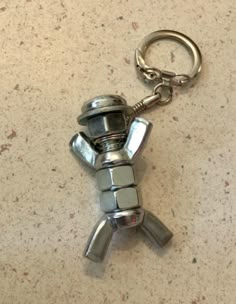 a metal keychain shaped like a robot