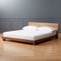 a bed sitting on top of a hard wood floor