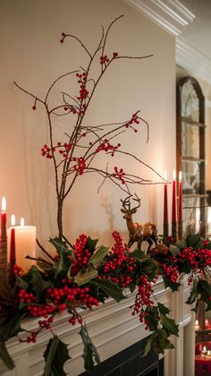 a christmas mantel decorated with holly and red berries