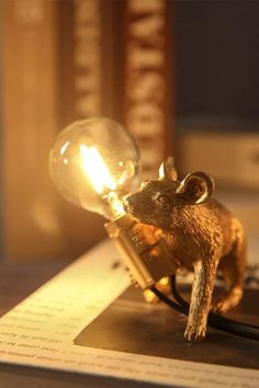 a mouse lamp sitting on top of a book