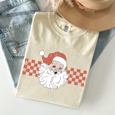 Get into the holiday spirit with our Christmas Comfort Colors Tees! These festive tees offer a blend of vintage style and cozy comfort, making them perfect for all your seasonal celebrations. Whether you're decorating the tree, attending holiday parties, or relaxing with family, these tees bring warmth and cheer to every occasion. 🎄 Key Features: 🧵 100% Ring-Spun Cotton: Experience the softness and durability of premium, ring-spun cotton that feels great all day long. 👕 Vintage-Inspired Look: Each tee features a unique dye process, giving it a classic, faded look that's full of holiday charm. 🌱 Eco-Friendly & Ethically Produced: Feel confident in your purchase with our commitment to sustainable and ethical practices. 🧍 Unisex Sizing: Designed to fit comfortably, our tees are available Retro Christmas Shirts, Vintage Christmas Shirt, Retro Christmas Shirt, Winter Schnee, Retro Santa, Seasonal Celebration, Holiday Colors, Winter Gift, Color Care