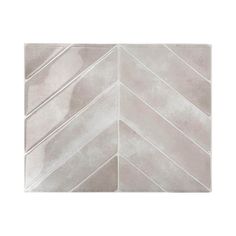 a white tile wall with an arrow pattern in the center and diagonals on it