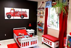 a child's bedroom decorated in red, white and black with a fire truck theme