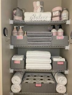 the shelves are organized with towels, soaps and other bathroom items in baskets on them