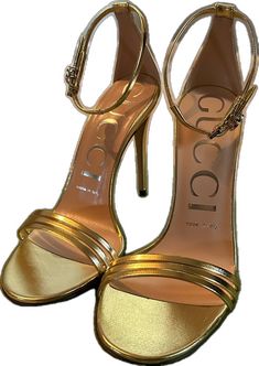 Luxury Gucci Evening Sandals, Gucci Ankle Strap Sandals For Formal Occasions, Gucci Luxury Formal Sandals, Designer Gold Ankle Strap Heels, Gucci Designer Formal Sandals, Gucci Designer Sandals For Formal Occasions, Designer Gold Heels With 4-inch Heel, Gucci Formal Sandals With Padded Heel, Gucci Party Sandals