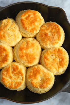 biscuits in a skillet on a marble counter top