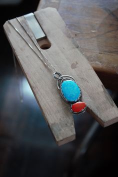 "This color combo is so beautiful! The turquoise is the perfect bright blue to compliment the red coral rosarita. Rosarita is essentially gold infused glass. It's a by product of gold refining. These beautiful stones are set in sterling silver. I wanted a unique way for this pendent to be hung, so I made two organic shaped arches that hold the two jump rings that the sterling silver necklace goes through. The sterling silver vintage chain is around 22\". The pendent is around an 1.5\" long." Southwestern Blue Cabochon Necklaces, Red Southwestern Sterling Silver Necklace, Southwestern Blue Cabochon Necklace, Southwestern Style Blue Cabochon Necklace, Macrame Choker, Gold Disc Necklace, Hemp Necklace, Vintage Chain, Boho Choker