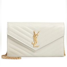 Indulge In Luxury With This Stunning Yves Saint Laurent Envelope Chain Purse. The Cream-Colored Leather Exterior Is Embossed And Quilted In A Chevron Pattern, Beautifully Accented By Gold Hardware And A Gold Chain Strap. This Shoulder Bag Features A Snap Closure And A Rectangle Shape, Perfect For Carrying All Your Essentials. Inside, The Black Lining Adds A Touch Of Sophistication While The Brand Card And Original Box And Dust Bag Provide Authenticity. Ideal For Any Occasion, This Saint Laurent Bag Is A Must-Have For Any Woman's Collection. White Luxury Wallet On Chain For Formal Occasions, Luxury White Wallet On Chain For Formal Occasions, White Chic Wallet On Chain For Formal Occasions, Chic White Wallet On Chain For Formal Occasions, Elegant White Wallet On Chain For Formal Occasions, Classic White Wallet On Chain For Formal Occasions, Luxury White Wallet On Chain For Evening, Elegant White Wallet On Chain For Evening, Formal White Rectangular Wallet On Chain