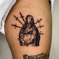 a woman with two swords on her thigh and the image of mary holding jesus is shown in black ink