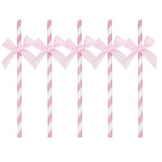 four pink and white striped candy sticks with bows on them, all lined up in a row