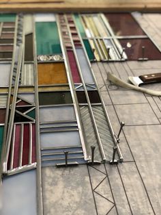 an assortment of stained glass windows on the side of a building