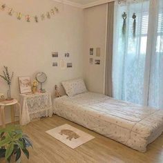 a bed room with a neatly made bed next to a window