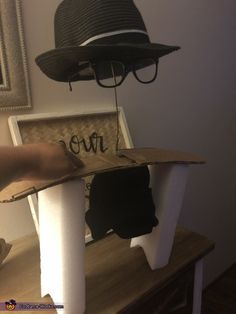 a hat is sitting on top of a chair with the word love written on it