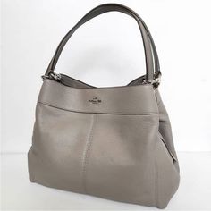 Coach Lexi Large Fog (Grey) Pebble Shoulder Bag Brand: Coach Color: Stone Interior: Stone Gray Fabric Lining, Middle Zipper Compartment And 2 Outer Compartments, Snap Closure, Slip Pocket Exterior: Handles With 9 1/2” Drop. Clean, No Flaws, Pet And Smoke Free Home. See All Photos Before Purchasing. No Refunds, Returns, Exchanges Or Cancellations During Live Auctions. I Do Accept Reasonable Offers, No Low-Balling. You Can Use Affirm At Checkout, Buy Here Pay Here. Photos Of Items Will Be Taken Du Coach Vintage Handbags, Coach Pillows, Rose Bag, Stone Interior, Brown Handbag, Coach Shoulder Bag, Gray Fabric, Black Shoulder Bag, Color Stone