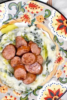 a plate filled with mashed potatoes and sausage