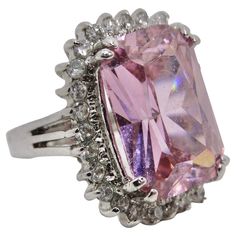 Introducing our dazzling 1990s Pink Synthetic Sapphire Silver Ring – a bold and vibrant statement piece that's perfect for those who adore the color pink. This ring combines the elegance of a synthetic sapphire with the sparkle of synthetic crystals, all encased in high-quality silver 925. This ring is all about celebrating the color pink. The synthetic sapphire at its center shines with a captivating pink hue, evoking feelings of love, passion, and femininity. The synthetic crystals surrounding Pink Rings For Formal Occasions, Dazzling Pink Rings For Formal Occasions, Pink Cubic Zirconia Party Rings, Dazzling Pink Formal Rings, Pink Gemstone Jewelry For Evening, Pink Oval Rings For Party, Pink Party Rings Fine Jewelry, Pink Crystal Ring For Formal Events, Fine Jewelry, Pink Crystal Ring For Formal Occasions