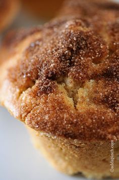 a close up of a muffin on a plate with sugar sprinkled on it