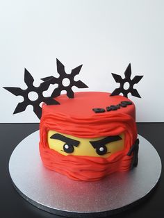 a lego ninja face cake with black stars on top