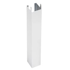 a tall white vase sitting on top of a white floor next to a metal pole