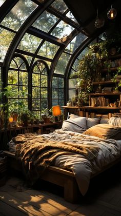 a bed sitting inside of a bedroom next to a window filled with potted plants